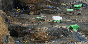 To go with Myanmar-China-mining-economy-politics-resources by Kelly MACNAMARA, Phyo Hein KYAW  This photo taken on October 4, 2015 shows freelance miners at a jade mine in Hpakant, Myanmar's Kachin State. Everyday rickety homes in a remote Myanmar village inch closer to a cliff edge as bulldozers owned by the nation's elite claw the earth beneath them, ravenously hunting jade to feed Chinas multi-billion dollar demand.     AFP PHOTO / Ye Aung THU        (Photo credit should read Ye Aung Thu/AFP/Getty Images)